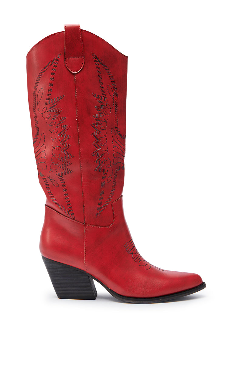 The IZABELLA WATERMELON WESTERN BOOT is a single knee-high red faux leather cowboy boot with black stitching, a pointed toe, and a slanted mid-height heel, shown against a white background.