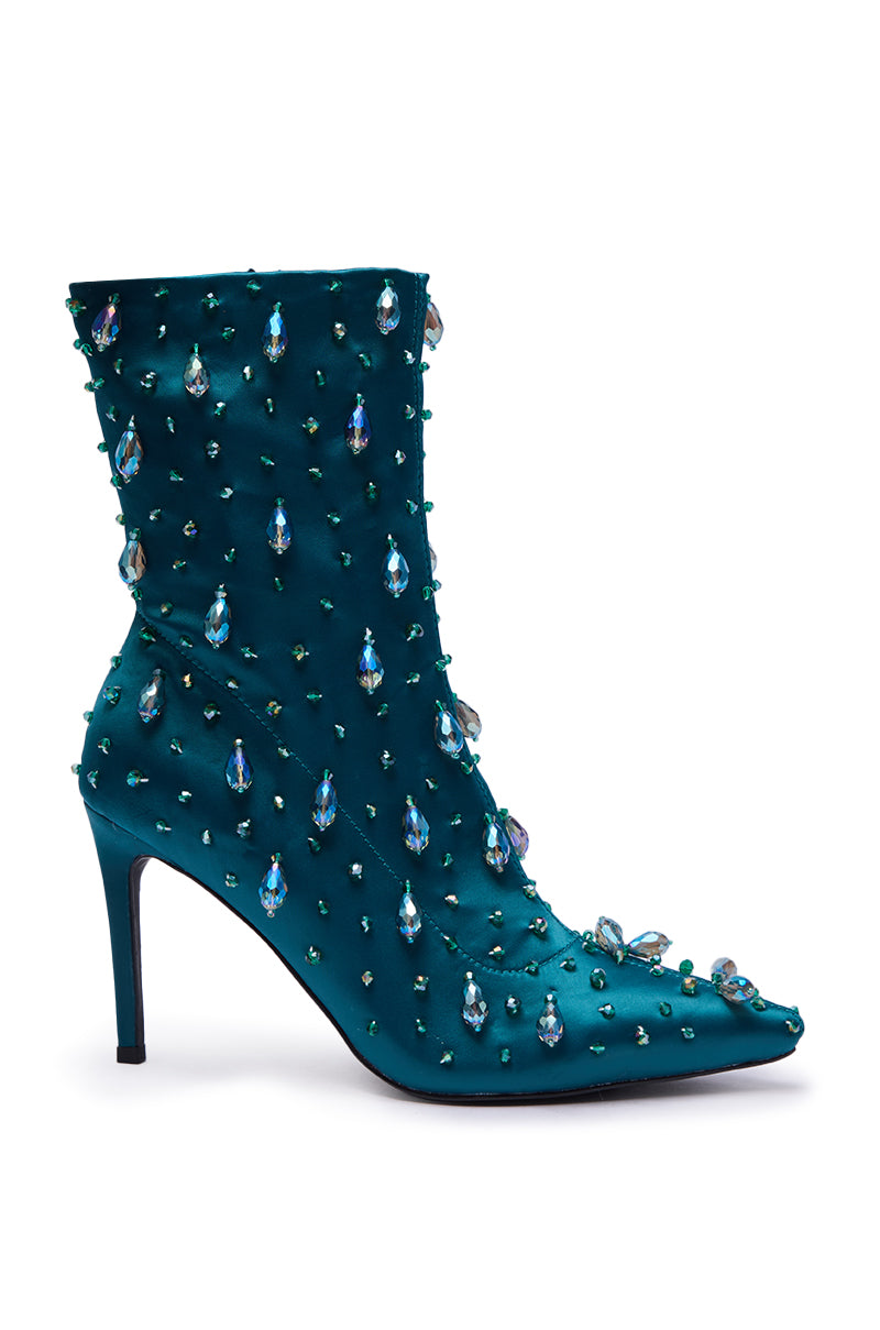 The AZALEA WANG IZIDOR TEAL EMBELLISHED RHINESTONE BOOTIE features teal satin, a pointed toe, sleek stiletto heel, and dazzles with teardrop and round blue gemstones for a sparkling finish.