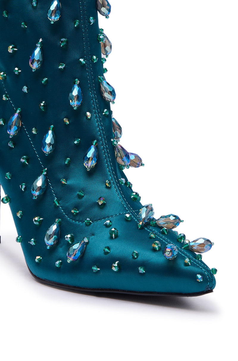 Close-up of the AZALEA WANG IZIDOR Teal Embellished Rhinestone Bootie, featuring a pointed stiletto heel and dazzling large and small iridescent gems for a glamorous, textured look—ideal for standout style.