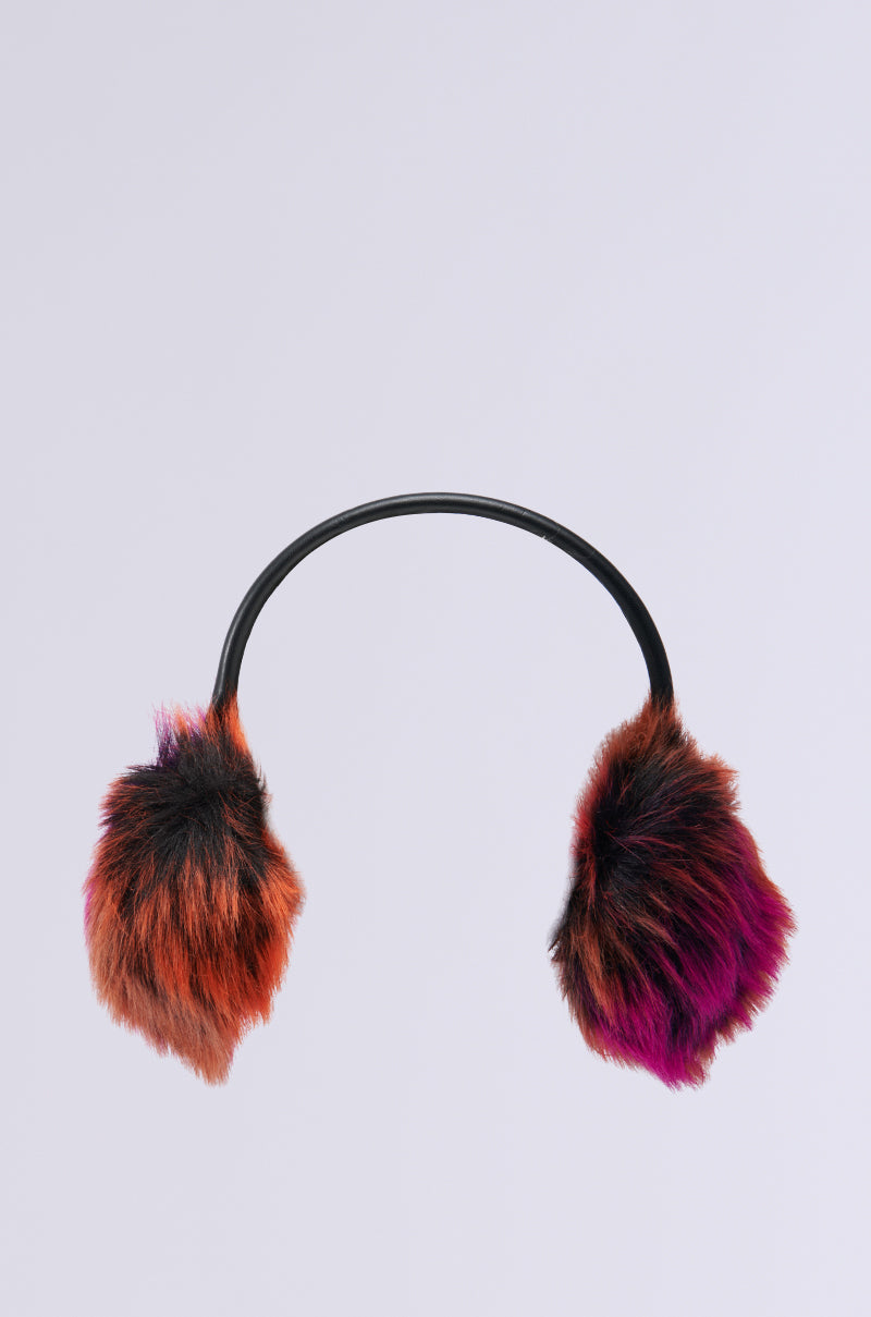 The GRACELLE FUR EAR MUFF from the AKIRA Label collection showcases soft faux fur earmuffs with a vibrant gradient transitioning smoothly from orange to purple on the ear pads, joined by a sleek black headband, set against a light gray backdrop.