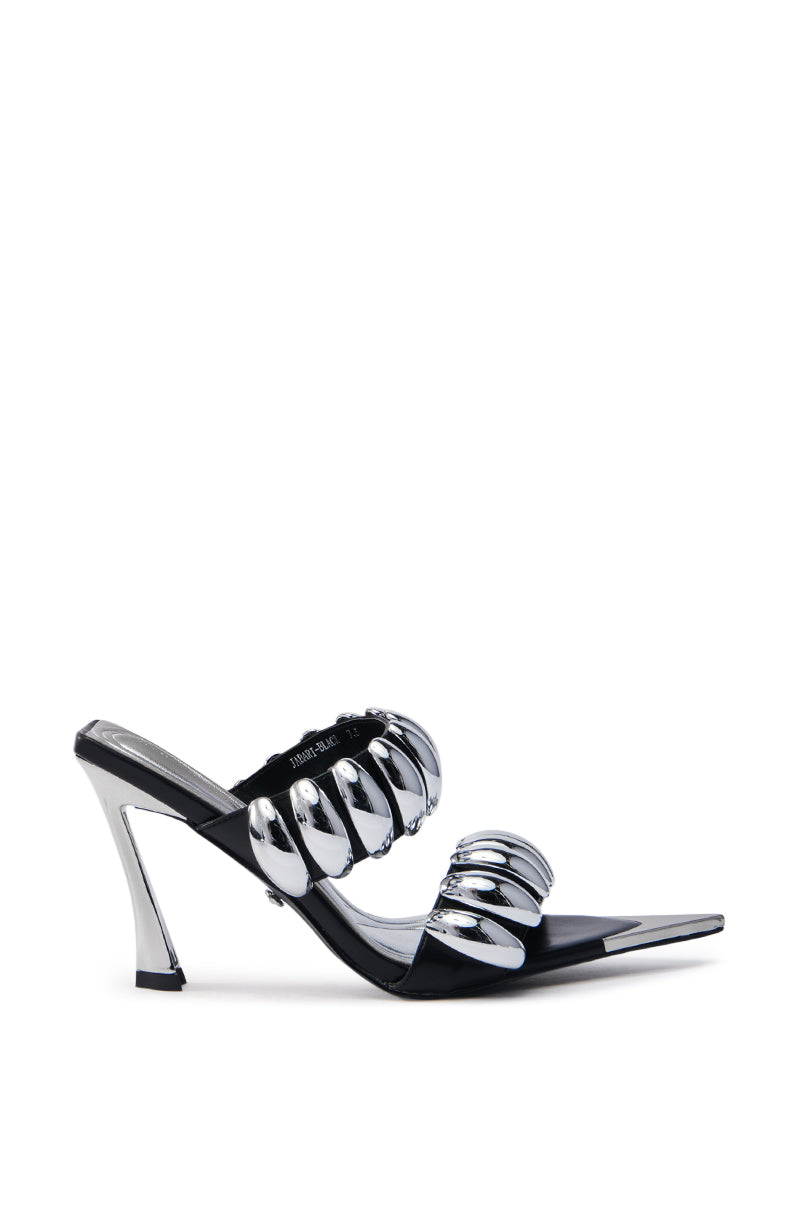 The AZALEA WANG JABARI BLACK STILETTO SANDAL is a modern vegan leather shoe with an angular heel, a sleek black base, open pointed toe, and two metallic silver straps, embellished with metallic hardware for a stylish look.