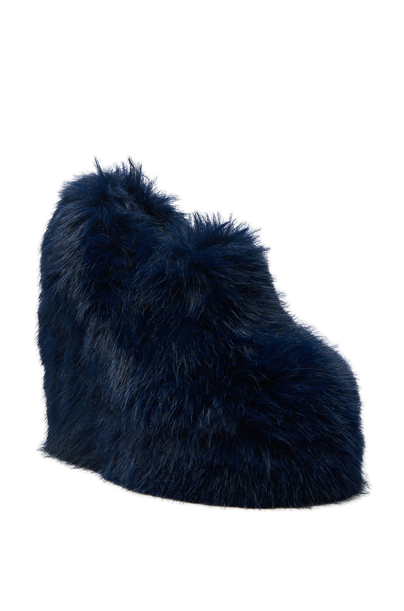 The AZALEA WANG JAEKE NAVY FUR WEDGE PUMP is a luxury women's shoe featuring a navy wedge heel covered in fluffy faux fur, shown against a white background.