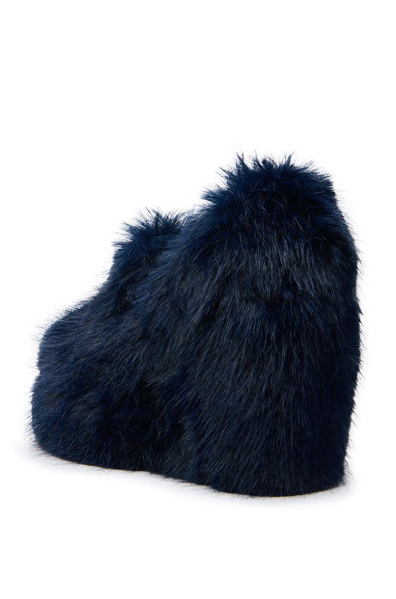 The AZALEA WANG JAEKE NAVY FUR WEDGE PUMP is a luxury women’s shoe covered in dark blue faux fur with a solid navy wedge heel, offering height and a chic, modern look without visible laces or embellishments.