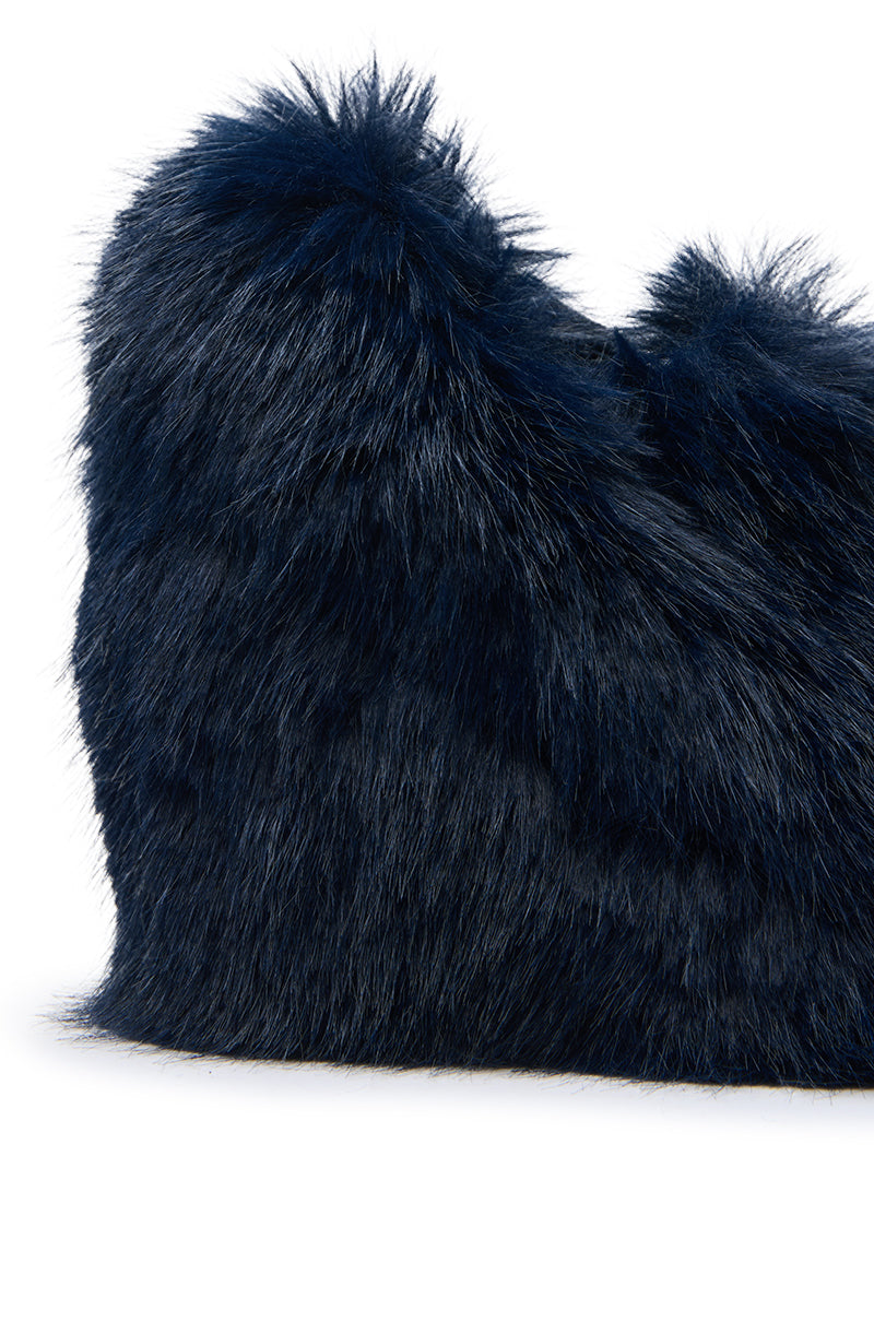 A close-up of a navy faux fur handbag against a white background. The plush fur mirrors the AZALEA WANG JAEKE NAVY FUR WEDGE PUMP, bringing an elegant, luxurious vibe to this chic accessory.