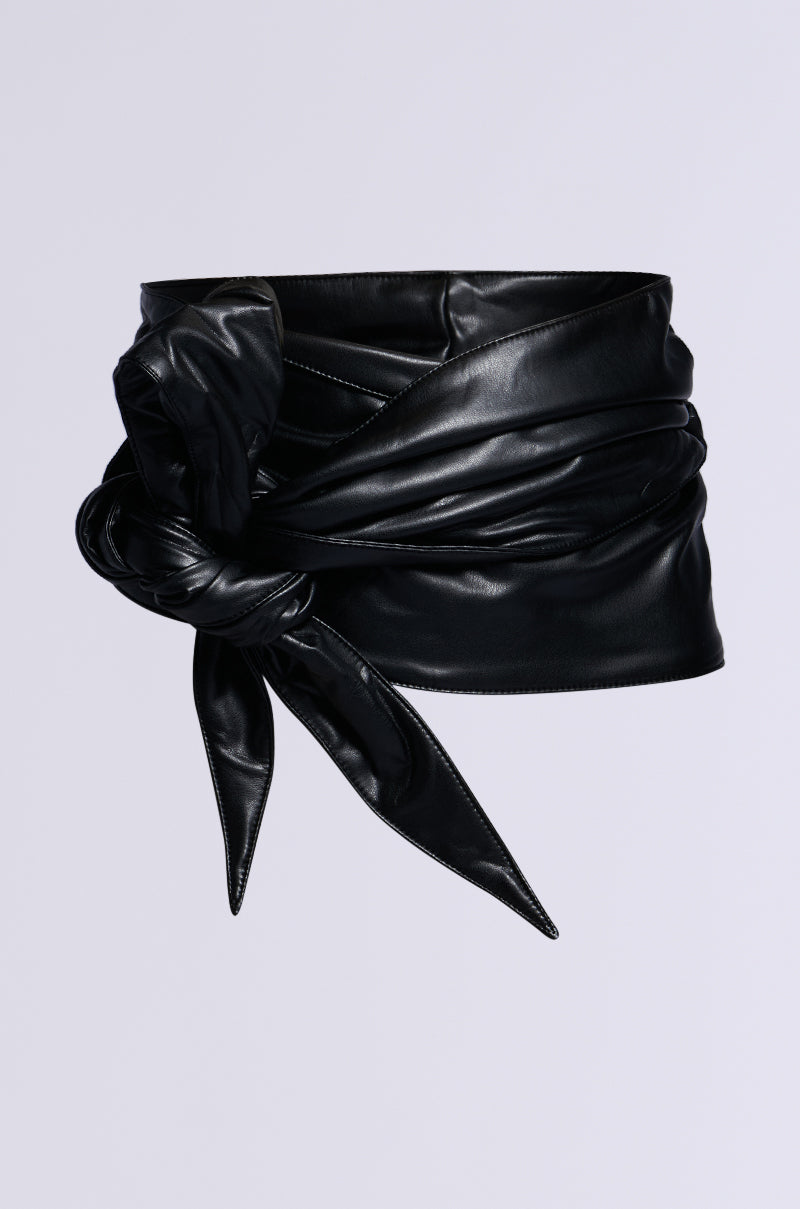 A chic ESSENTIAL WRAP AROUND TIE BLACK BELT in black faux leather with a stylish side tie knot on a plain white background.