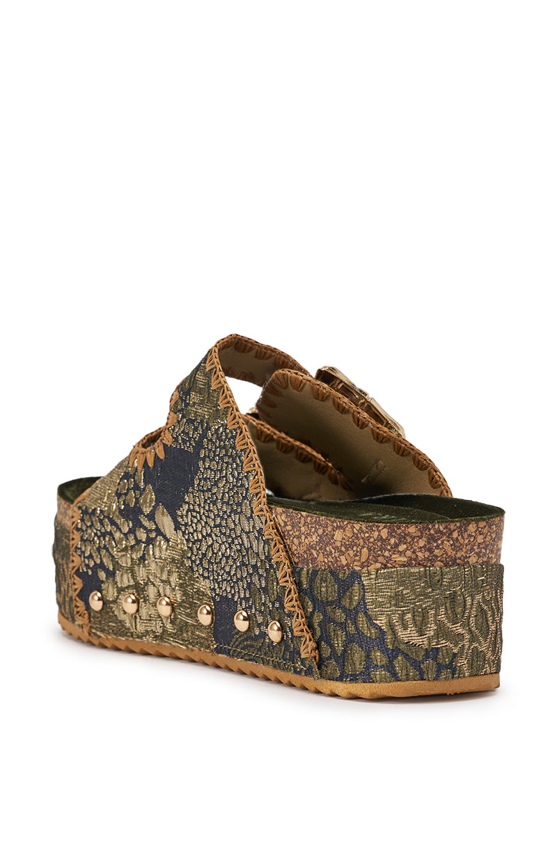 The AZALEA WANG JAINNA GREEN VELVET FLATFORM SANDAL features a thick green and gold brocade platform sole and upper, with earth tones, metallic studs, a patchwork texture, and an open toe. 5