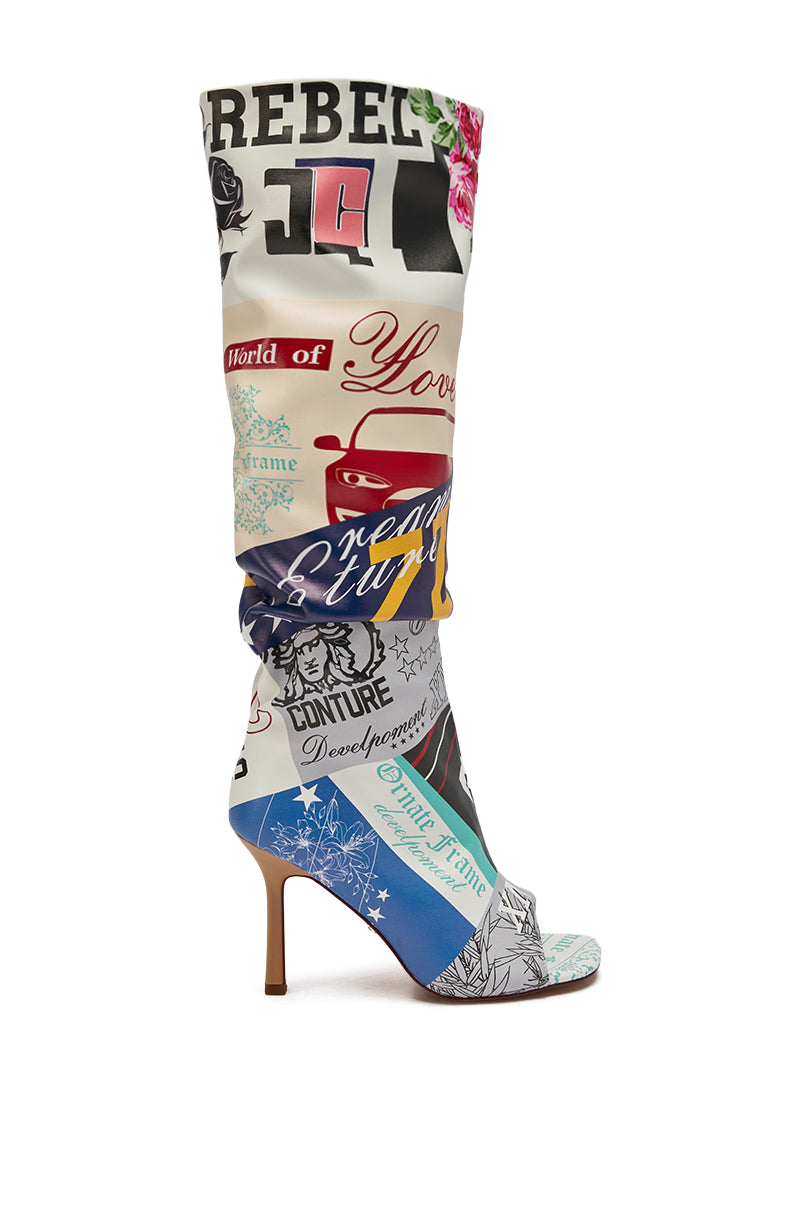 The AZALEA WANG JALISA MULTI NOVELTY PRINTED OPEN TOE BOOT features a high stiletto heel, slouchy shaft, and bold patchwork of colorful prints—flowers, cartoon cars, and playful phrases—on a chic, open-toe silhouette.