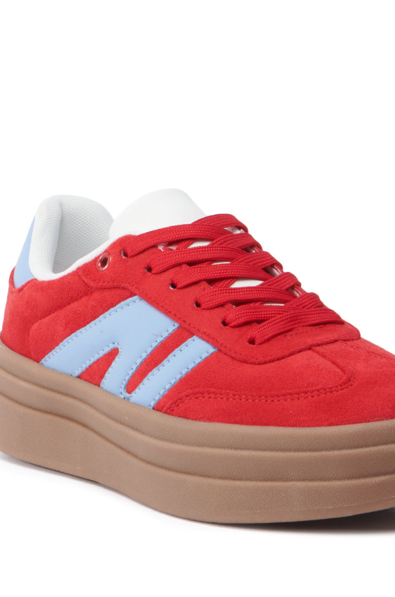 The AZALEA WANG JUMBALAYA RED PLATFORM SNEAKER features a thick beige sole, an almond toe design, striking light blue side stripes, white accents around the ankle, and bold red laces.
