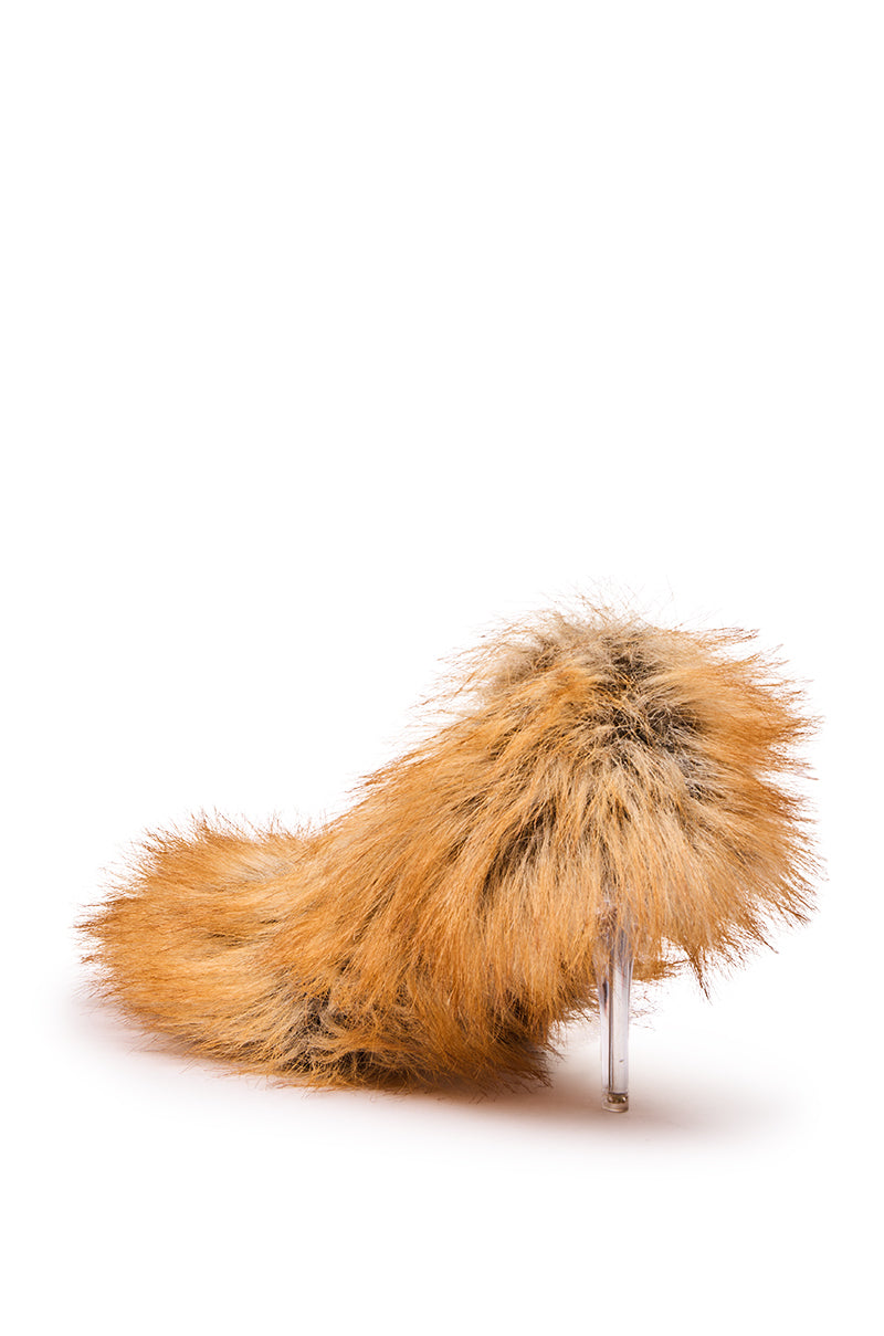 The AZALEA WANG JAMEECK TAN FUR PUMP features shaggy orange-brown faux fur and a clear stiletto heel, shown against a plain white background.