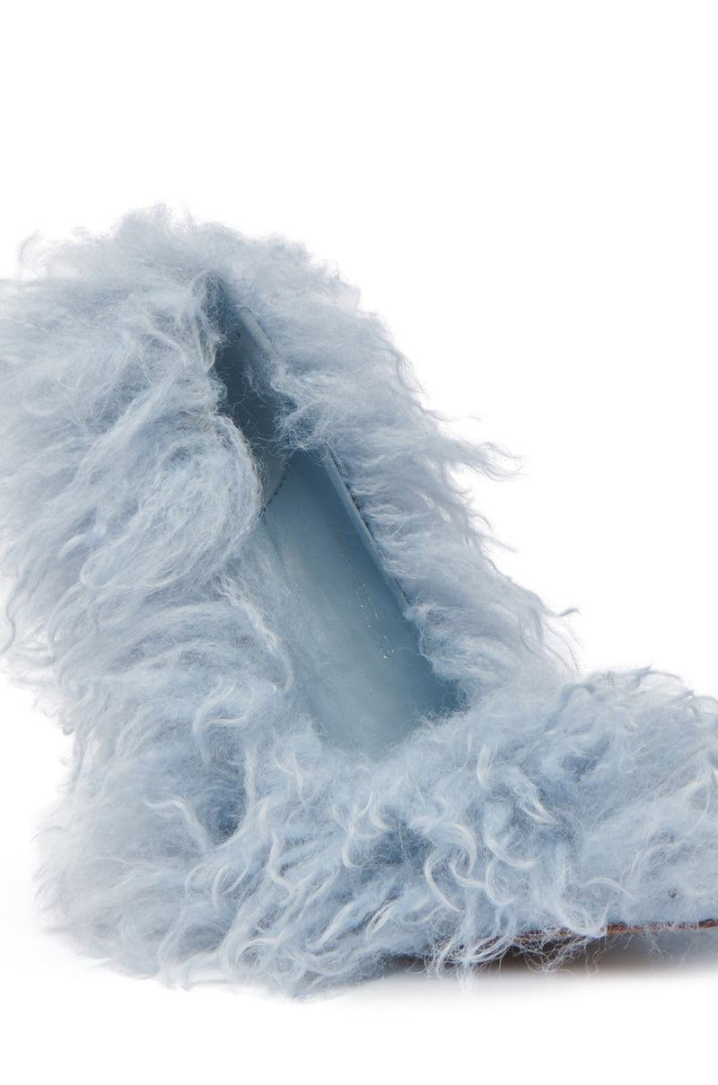 The AZALEA WANG JAMEELA BABY BLUE FUR HEEL showcases a sophisticated pointed-toe design with sleek blue high heels adorned with soft, fluffy faux fur, creating an elegant contrast against a plain white background.