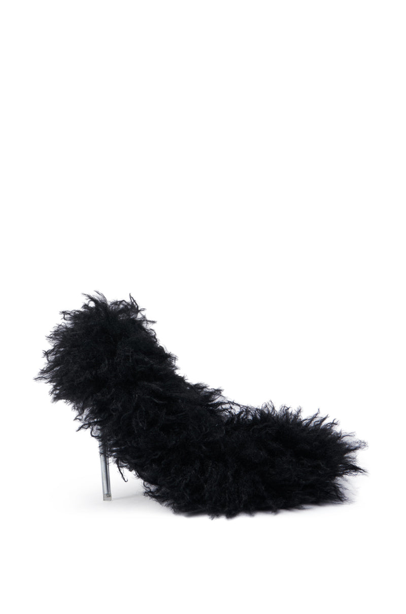 The AZALEA WANG JAMEELA BLACK FUR STILETTO PUMP features a fluffy texture with an abstract, shaggy design. The slender metallic heel provides a striking contrast to the faux fur look, while the interior is equipped with a Comfort Cushion Insole. Displayed against a plain white background, it emphasizes its distinctive elegance.