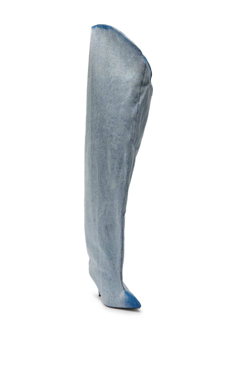 The AKIRA GOLD JANELISSE DENIM STILETTO BOOT, a light blue slouchy knee-high pointed-toe denim boot with a low heel, is displayed against a white background. 4