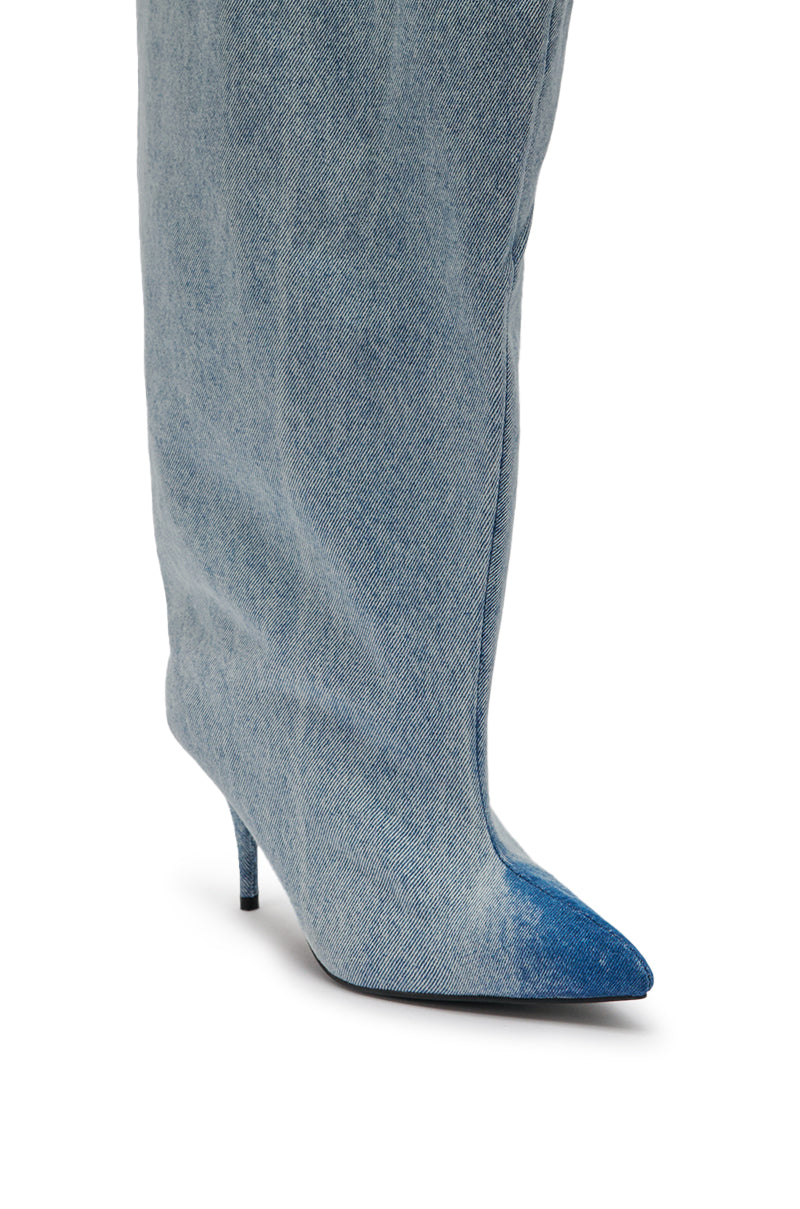 Close-up of the AKIRA GOLD JANELISSE DENIM STILETTO BOOT, a tall pointed-toe boot crafted from light blue denim and featuring a slim, high heel. 6