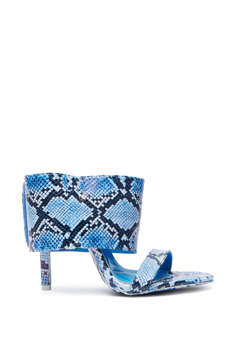 The AZALEA WANG JANSEN BLUE SNAKE STILETTO SANDAL, made from vegan leather, showcases a chic snakeskin pattern with a wide strap over the foot and another over the toes, complemented by a sleek stiletto heel for a modern look.