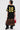 A person faces away, wearing the CITY GIRL LAYERED JERSEY MIDI DRESS—a black oversized jersey with yellow stripes and number 19—styled with a leopard skirt with lace trim, black heeled boots, and a red handbag.