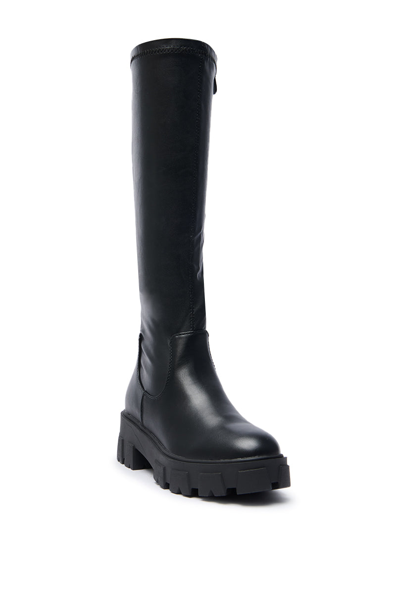 The AZALEA WANG JAYE Knee High Boot in Black features a smooth leather upper and chunky, textured sole, displayed at a slight angle against a white background.