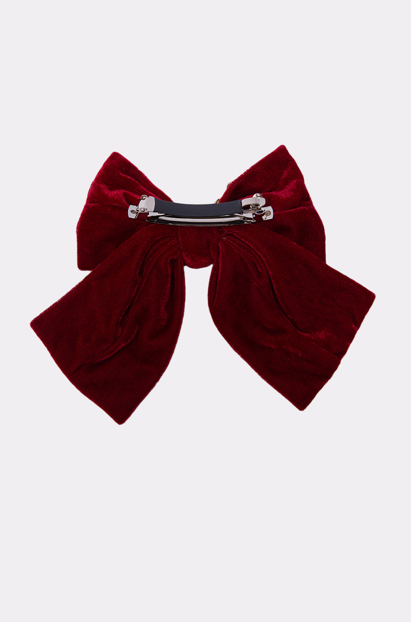 The JENNI EMBELLISHED HAIR BOW is a large, deep red velvet bow with wide ribbon tails and a silver metal barrette clip, elegantly displayed on a plain white background. 2