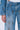Wearing KEY TO THE CITY RELAXED FIT JEANS and a matching key-adorned jacket, someone stands against a plain light background.