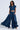 Against a plain light background, a woman models her chic style in a short-sleeved cropped dark wash denim jacket paired with CARRIE ULTRA WIDE LEG DENIM TROUSERS, hands in pockets.