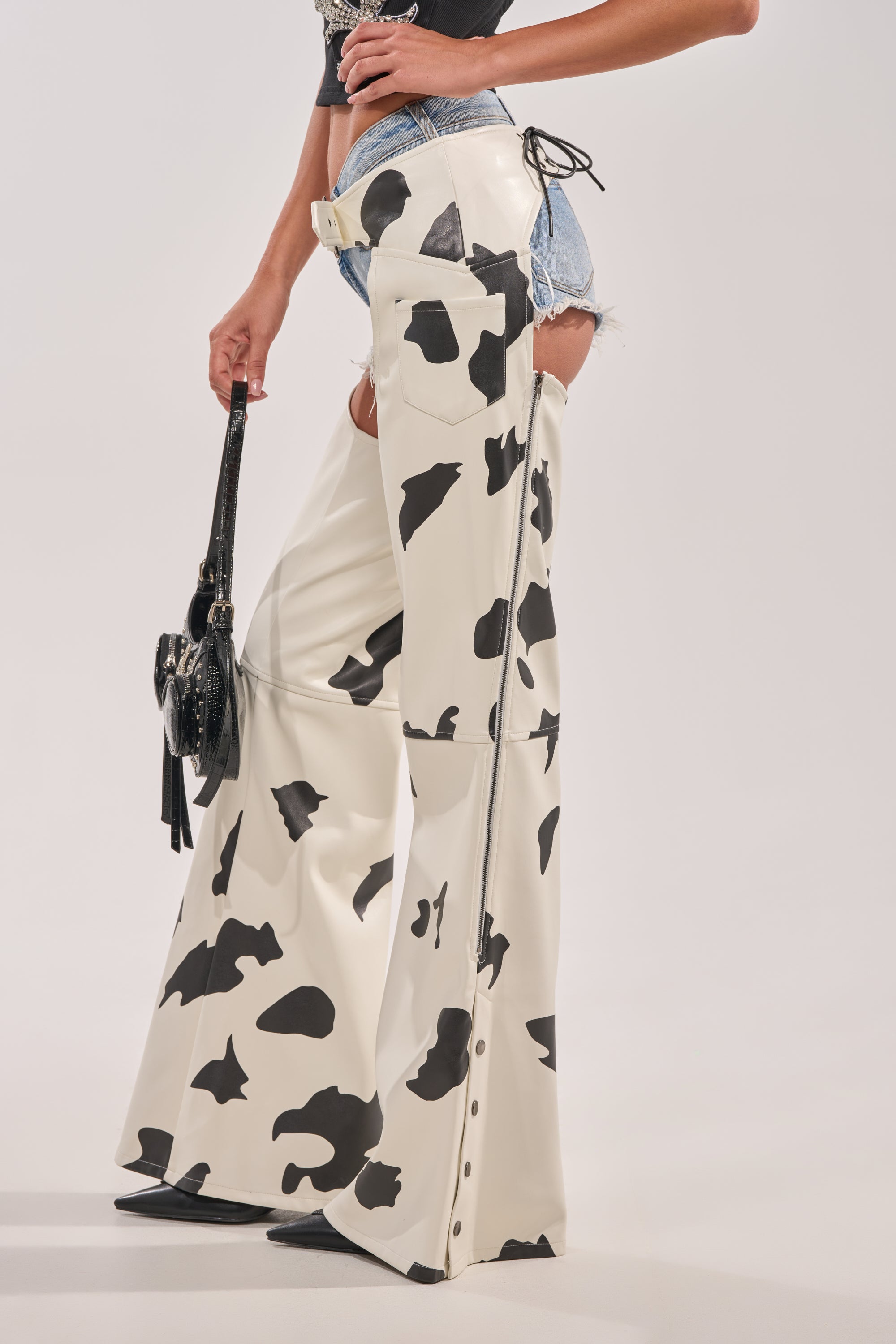 AKIRA Moo Over Cow Print Faux Leather Chaps | Black