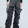 Wearing the "OH YEAH BABY BLACK WASH DENIM PANT," a person in relaxed mid-rise black denim stands against a plain background, pairing them with a black cropped top and accessorizing with a small silver handbag and open-toed black heels.