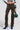 The ensemble features a person in MAKE A MOVE CAMO PANTS paired with vibrant blue high-heel boots, holding a round, green bag. The plain background highlights the cargo-style pockets on the lower half, adding both practicality and style to this bold look.