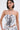 A woman with straight black hair wears the READ ME CORSET, a monochrome abstract print strapless top with a sweetheart neckline and side ties. She accessorizes with hoop earrings and a charm choker necklace.