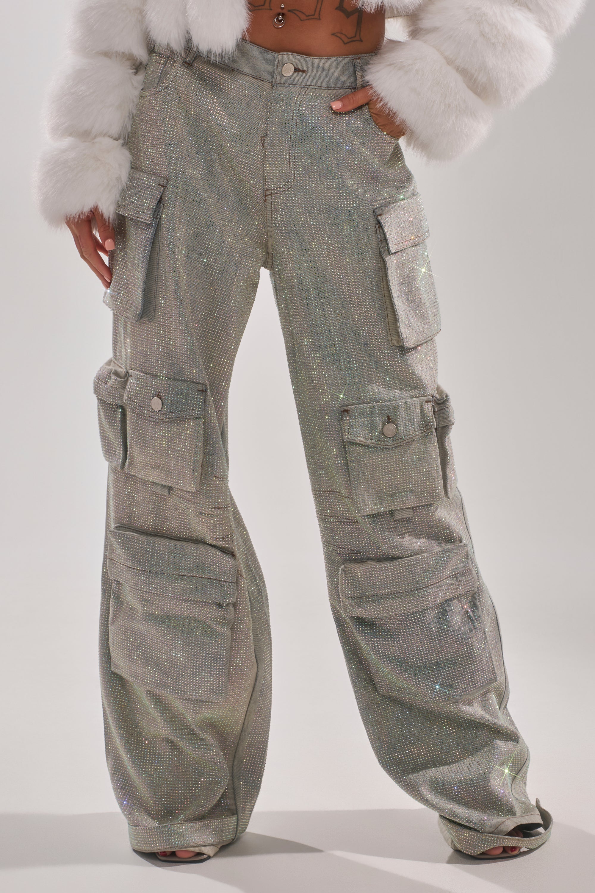 Wearing BLING BLING CARGO DENIM with a shimmering finish, multiple large pockets, and a loose fit, paired with a white faux fur jacket for a trendy look similar to high-rise wide-leg jeans. 0