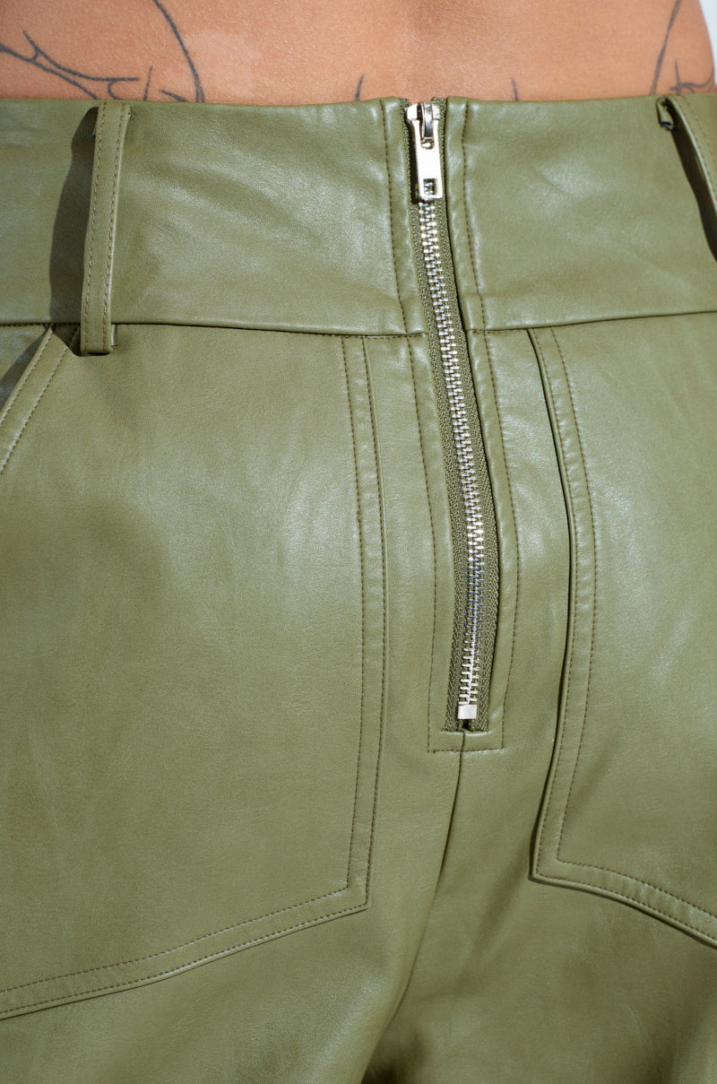 Close-up of AMY TROUSER IN OLIVE, featuring a high-rise design with a visible back zipper. These pants include belt loops and prominent pocket stitching, combining style and functionality.