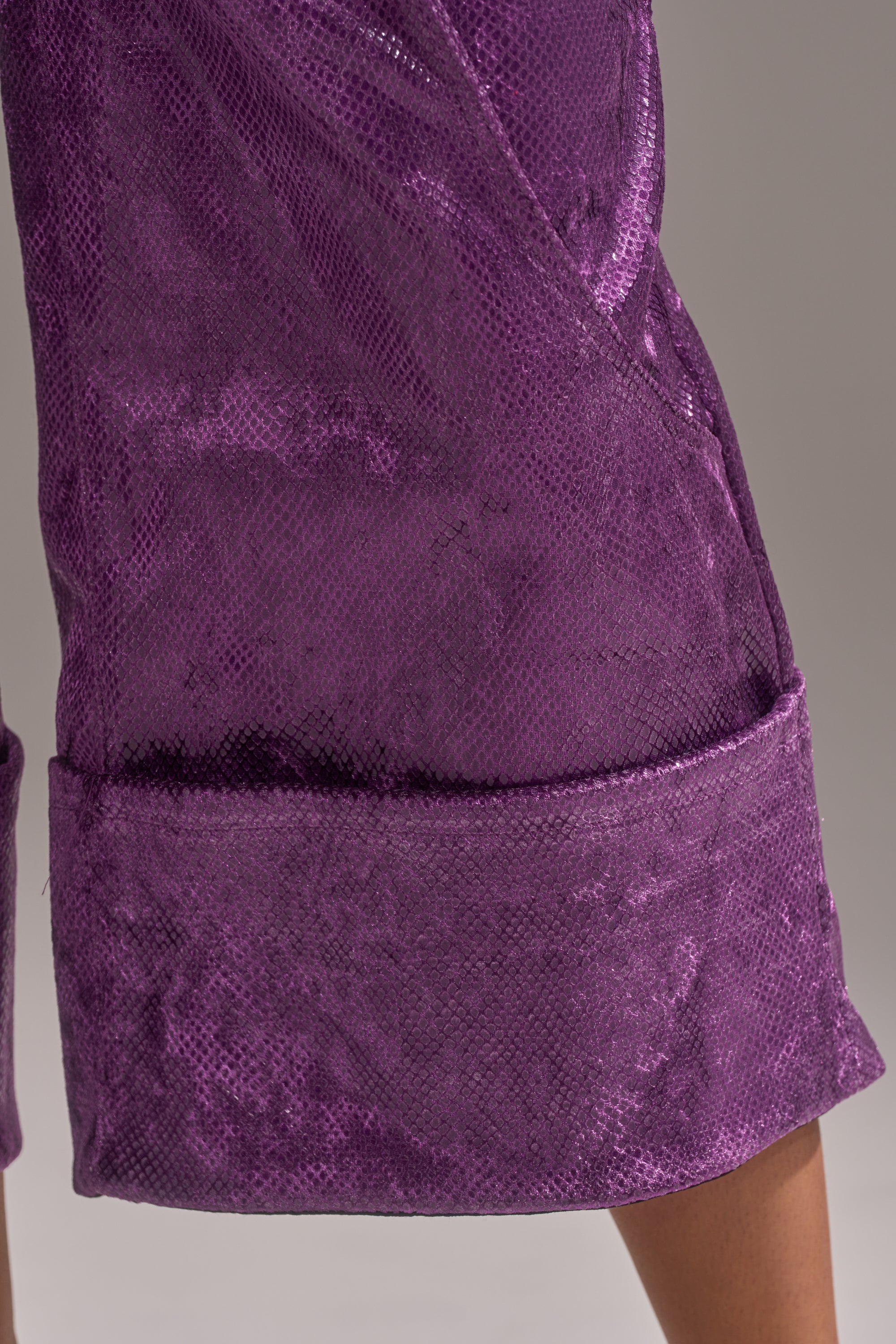 A close-up of the CRAZY TOUCH VELVET TROUSER in purple, featuring a textured, slightly shiny velvet surface and wide hem, styled with culottes and worn against a neutral background.