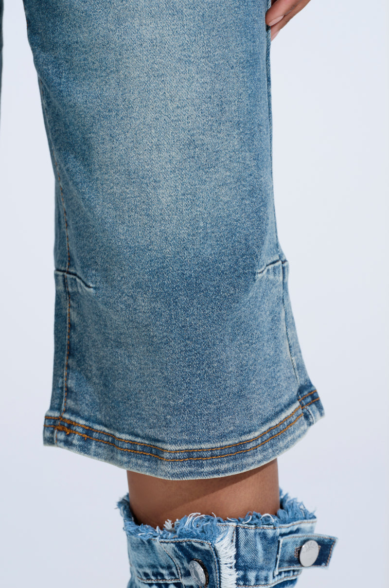 A close-up of someone wearing BREAK UP WITH HIM DENIM SHORTS in light blue features distressed details, frayed hems, and a faded look, paired with matching fabric against a plain white backdrop.