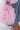 Close-up of the FLOWER GIRLIE APPLIQUE DENIM JEANS featuring sheer pink organza flower-shaped ruffles at the high-rise, wide-leg hem, with a pink sandal visible below.