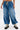 A person wears the DONT MESS WITH ME DENIM JOGGER—high-rise, wide-leg denim cargo pants with patch pockets and a drawstring waist—styled with chunky black lace-up boots, creating a standout streetwear look on a plain white background.