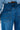 Close-up of a person wearing the GONE BAD DENIM BERMUDA SHORT in blue. The focus is on the back pocket details and stitching, highlighting the modern look of these high-rise style shorts.