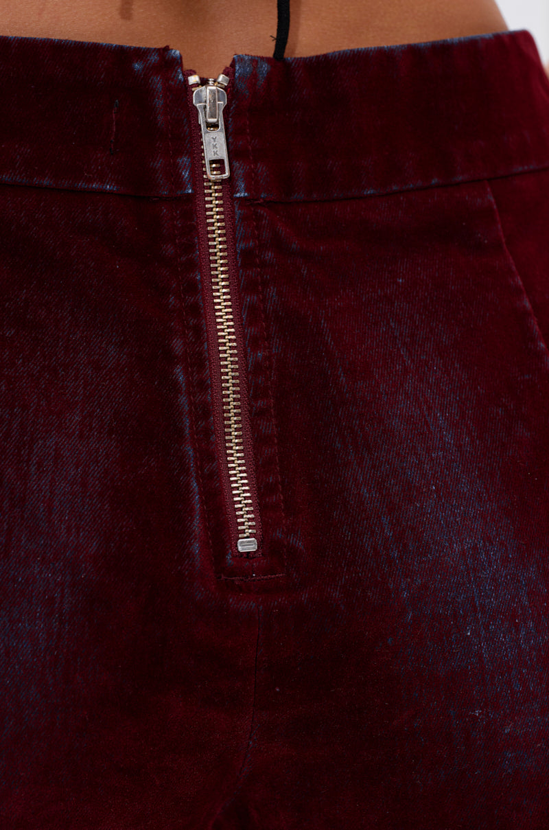 Close-up of the metallic front zipper on THE BEST VELVET DENIM HOT SHORT, made from deep burgundy velvet with a soft, subtly shiny finish and high-rise fit for a sleek look. 7