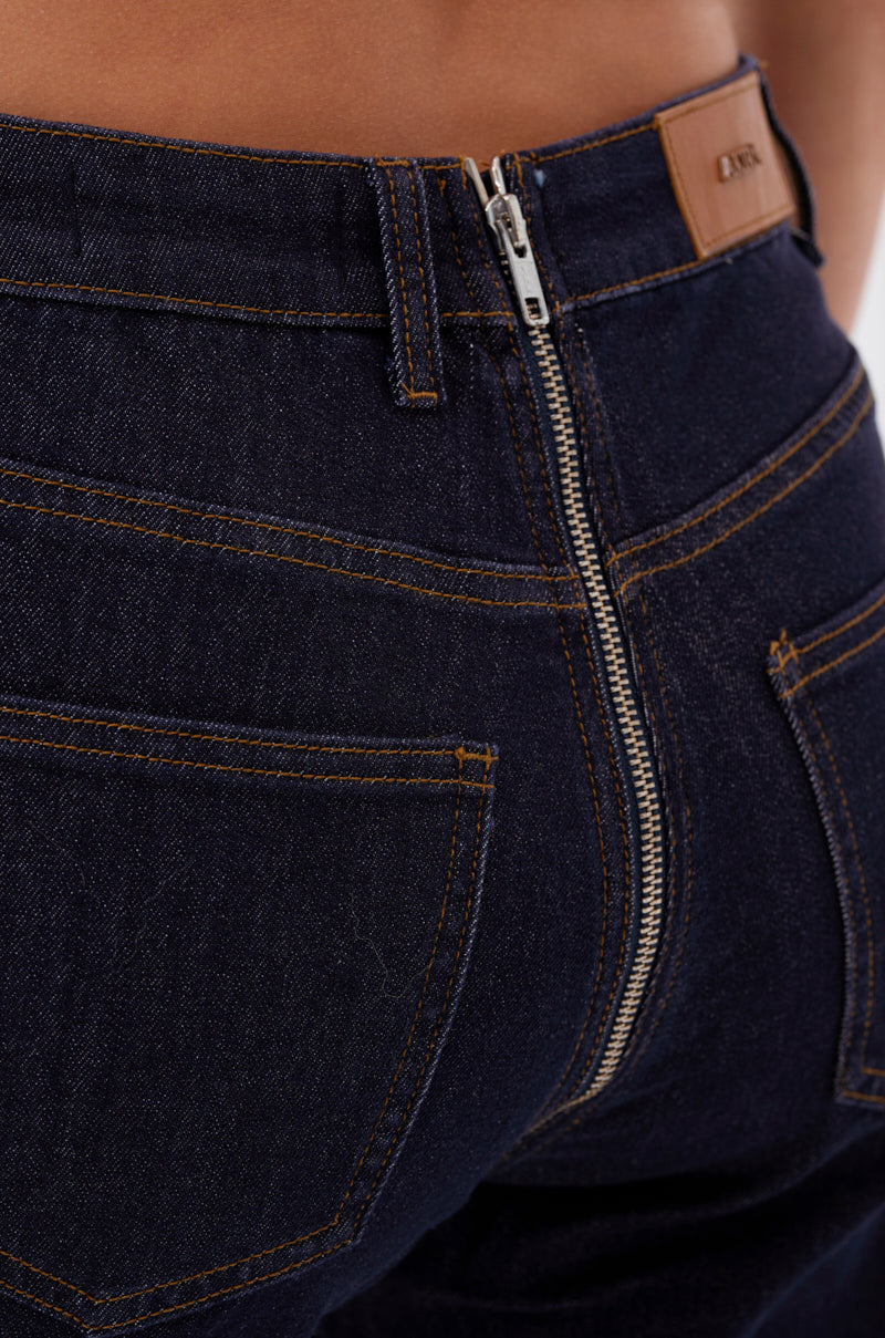 Close-up of the back of the GET CRAZY RUCHED DENIM PANT in dark blue with contrasting stitching, back pockets, a visible silver zipper, and a brown leather patch on the waistband. 6
