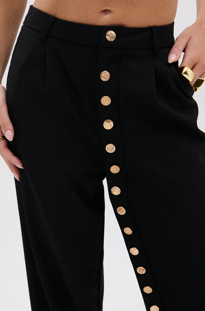 Wearing the BUTTONED UP STRAIGHT LEG PANT with metallic gold buttons and accessorizing with gold rings creates a striking, elegant look. 6