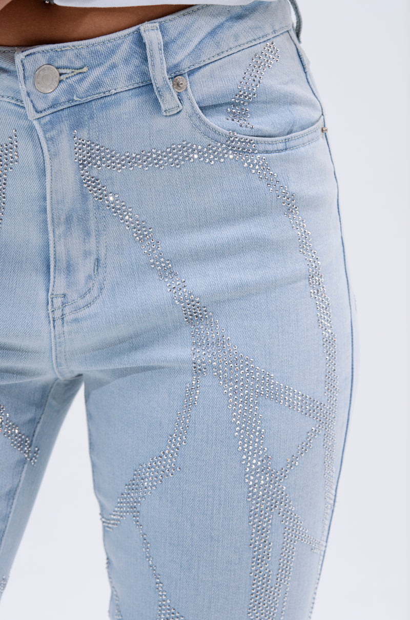 Close-up of SPIDER GIRL SKINNY DENIM: light blue, high-rise skinny jeans with silver rhinestone abstract patterns on the front, button closure, and visible front pockets. 7
