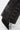 Close-up of a person wearing black pointed-toe shoes and the ROCK MY WORLD FAUX LEATHER LACE UO PANT, featuring side seams with metal eyelets and crisscrossed lace-up detailing.