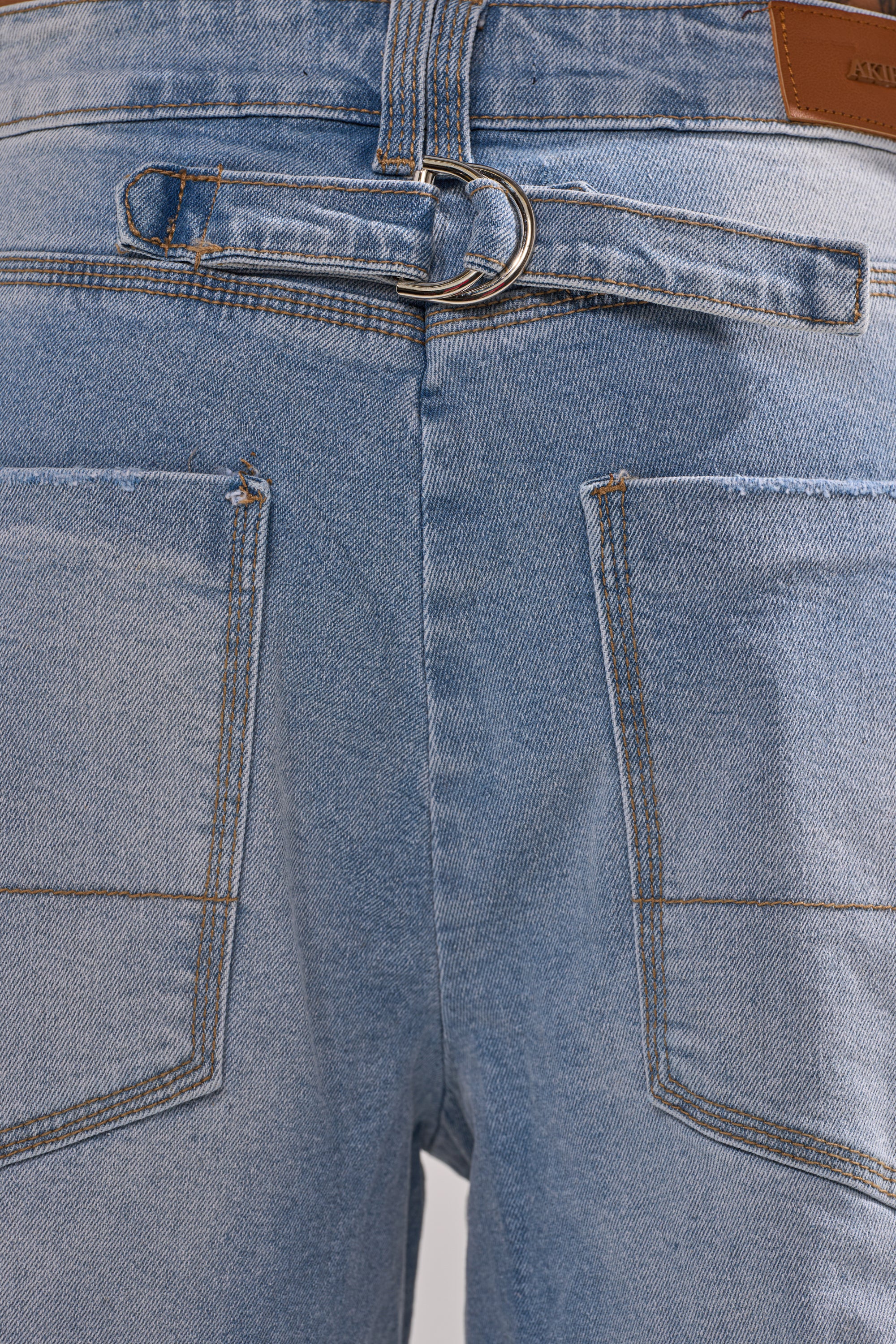 Close-up of the back of the ROCK MY WORLD WIDE-LEG DENIM BERMUDA SHORTS in light blue, showing two back pockets, brown stitching, belt loop, and a brown leather patch by the waistband for a workwear-inspired look.