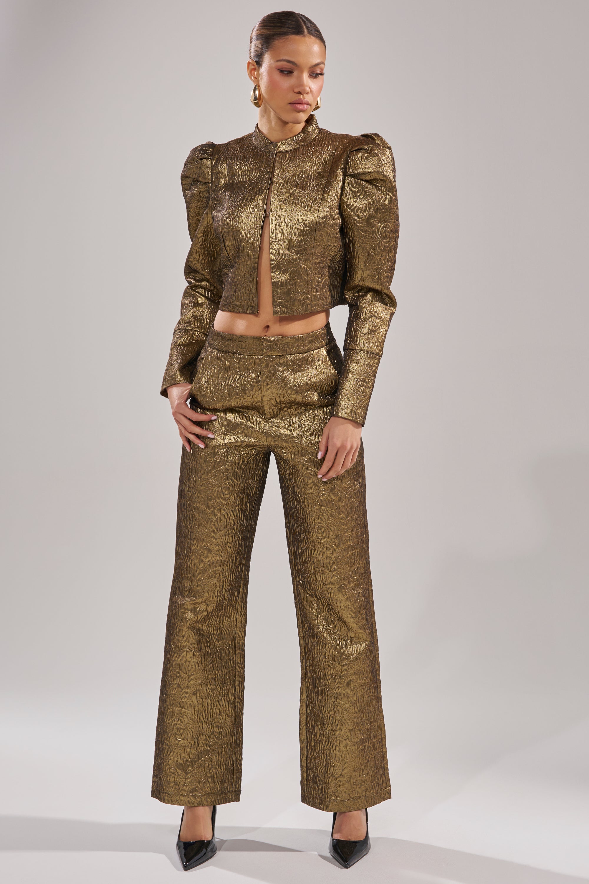 A woman wearing the DAPHNE BROCADE TROUSER, a high-waisted style in gold brocade. 3