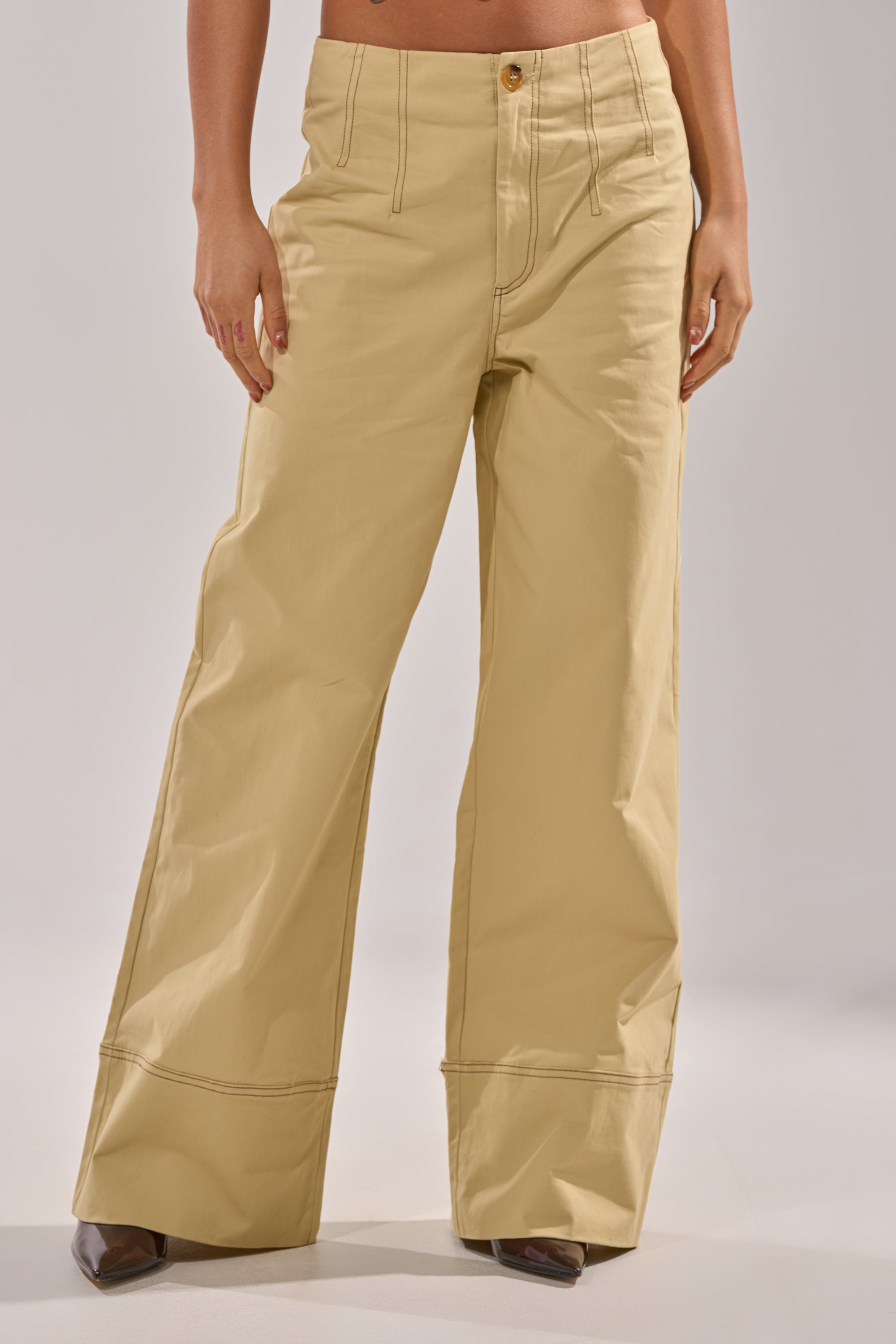 A person models the DIANA WIDE LEG PANTS in khaki, featuring a high-rise waist and visible stitching, against a plain light background. Only the lower torso and legs are shown. 1