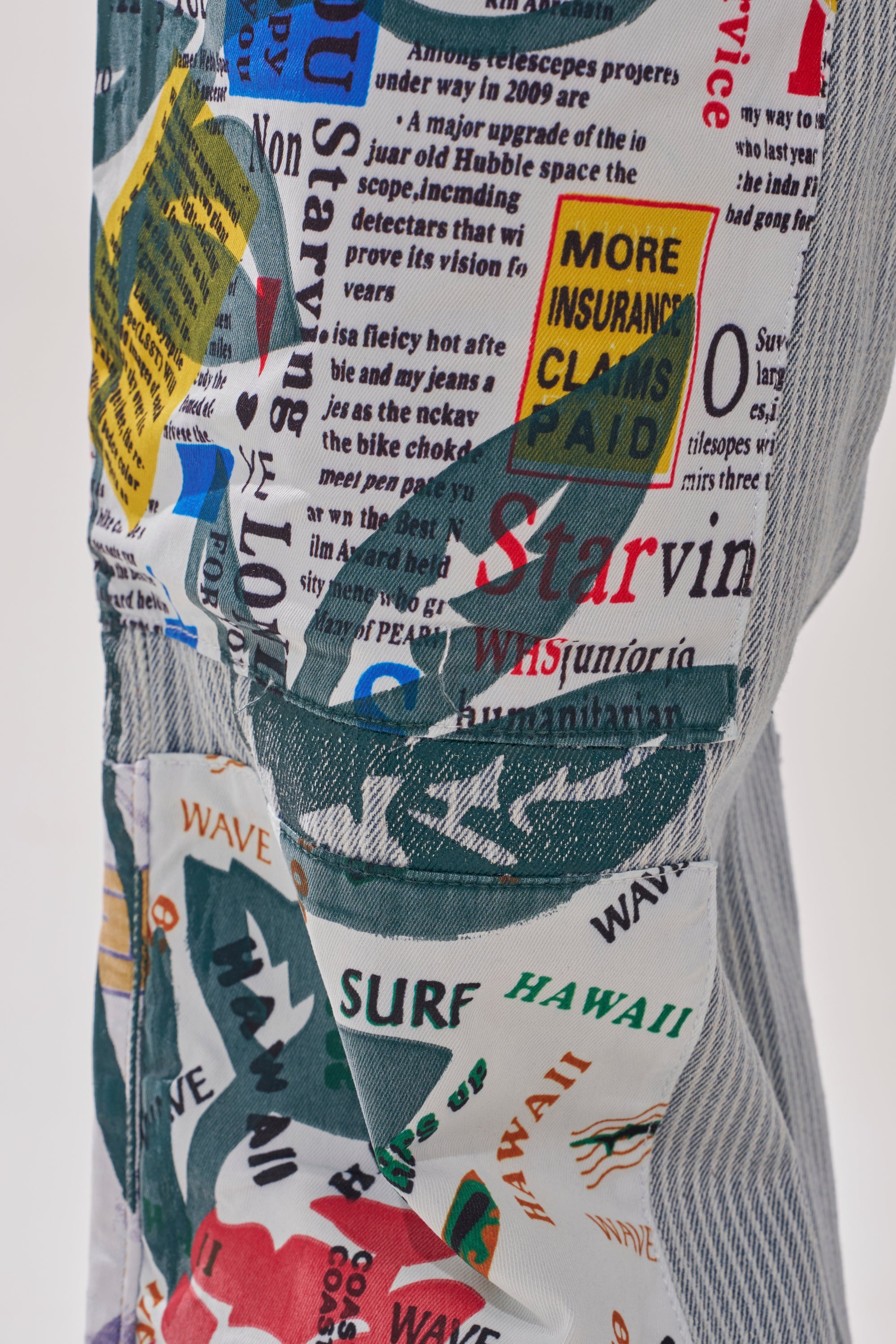 A close-up of the CIAO BELLA STRIPE TROUSER shows vibrant patchwork pants with colorful, overlapping text and graphics in various fonts—like "MORE INSURANCE CLAIMS PAID"—creating a bold, eye-catching look. 8