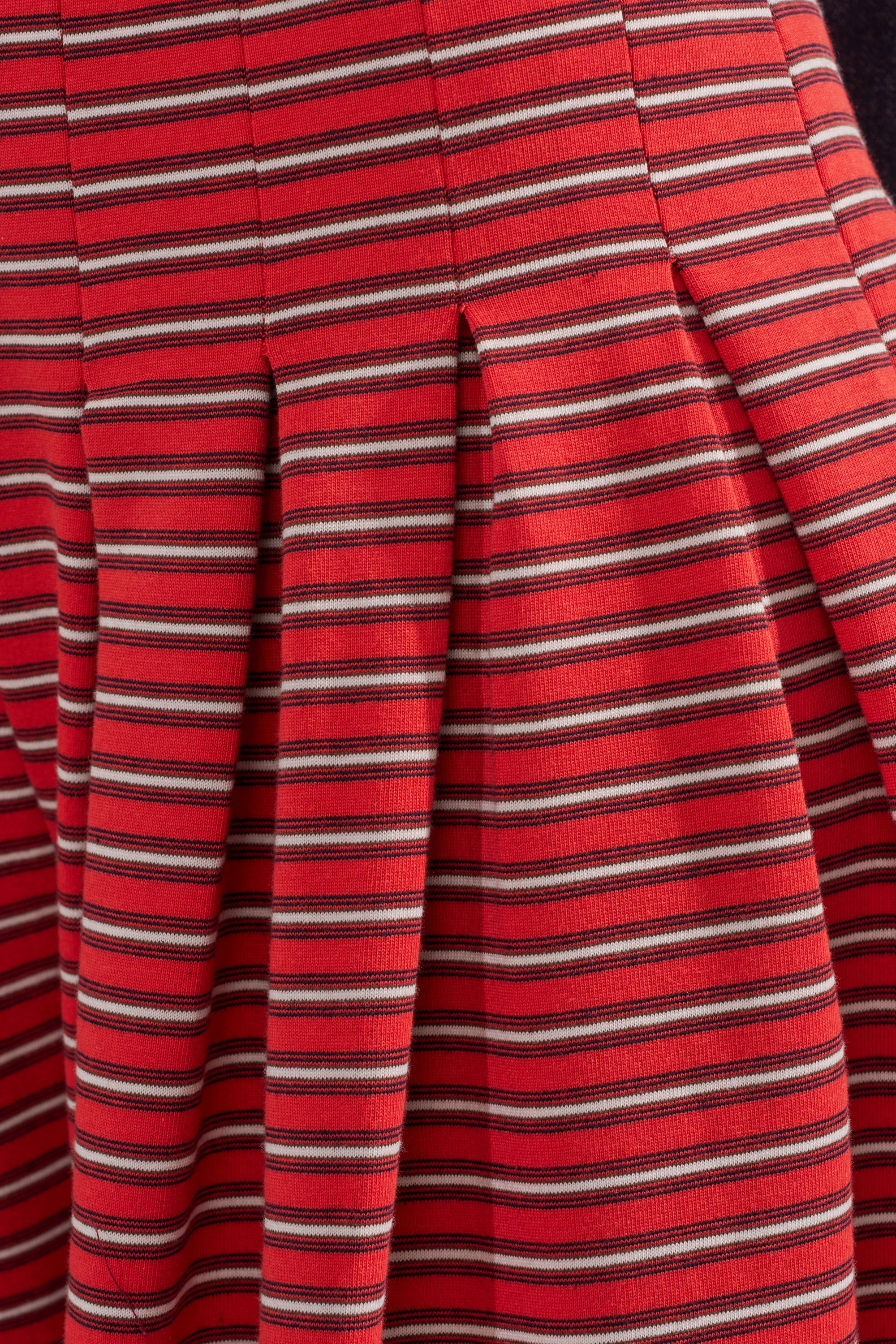 Close-up of SILVER COAST STRIPE TROUSER: red cotton wide-leg pants with horizontal black and white stripes, pleats for a flared, textured look. 6
