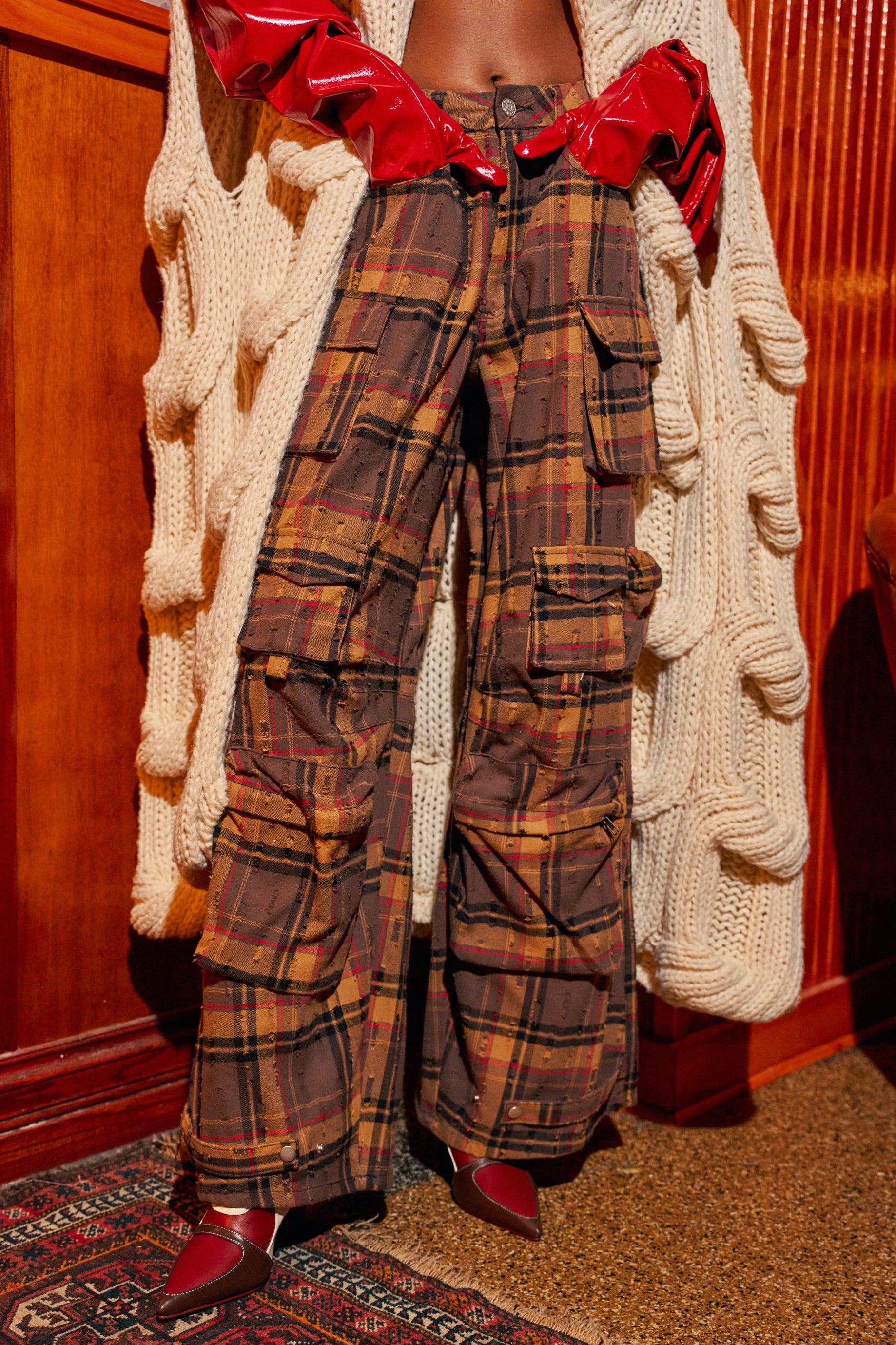 COOLEST ON THE BLOCK PLAID TROUSER: brown plaid cargo trousers with multiple side pockets.