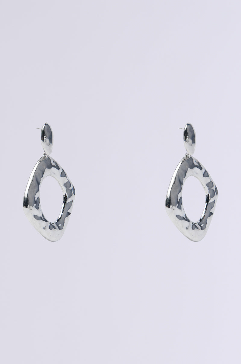 The NEVER BENT STATEMENT EARRING features faux silver dangle earrings with a textured open square design and round studs, creating a standout look against a white backdrop.