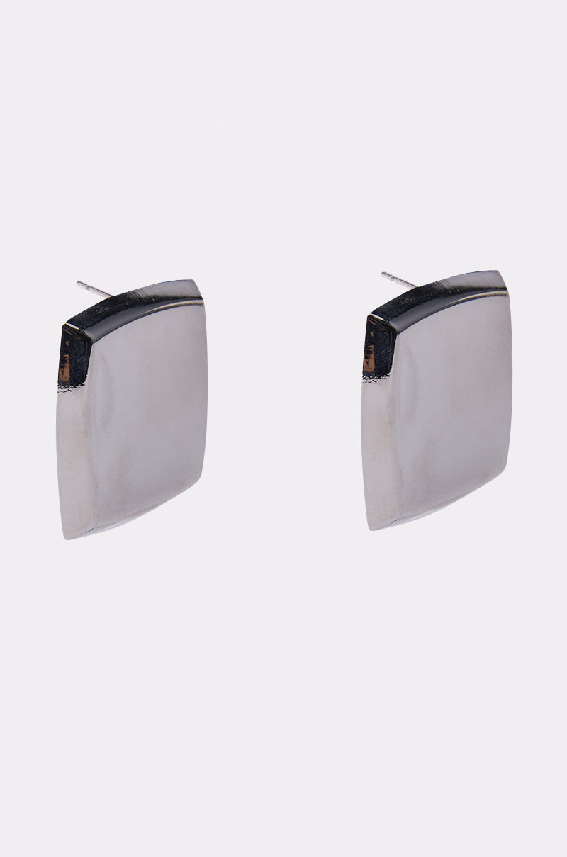The NOT A SQUARE EARRING features a minimalist design with slightly curved, silver-toned square surfaces, shown against a plain white background. 2