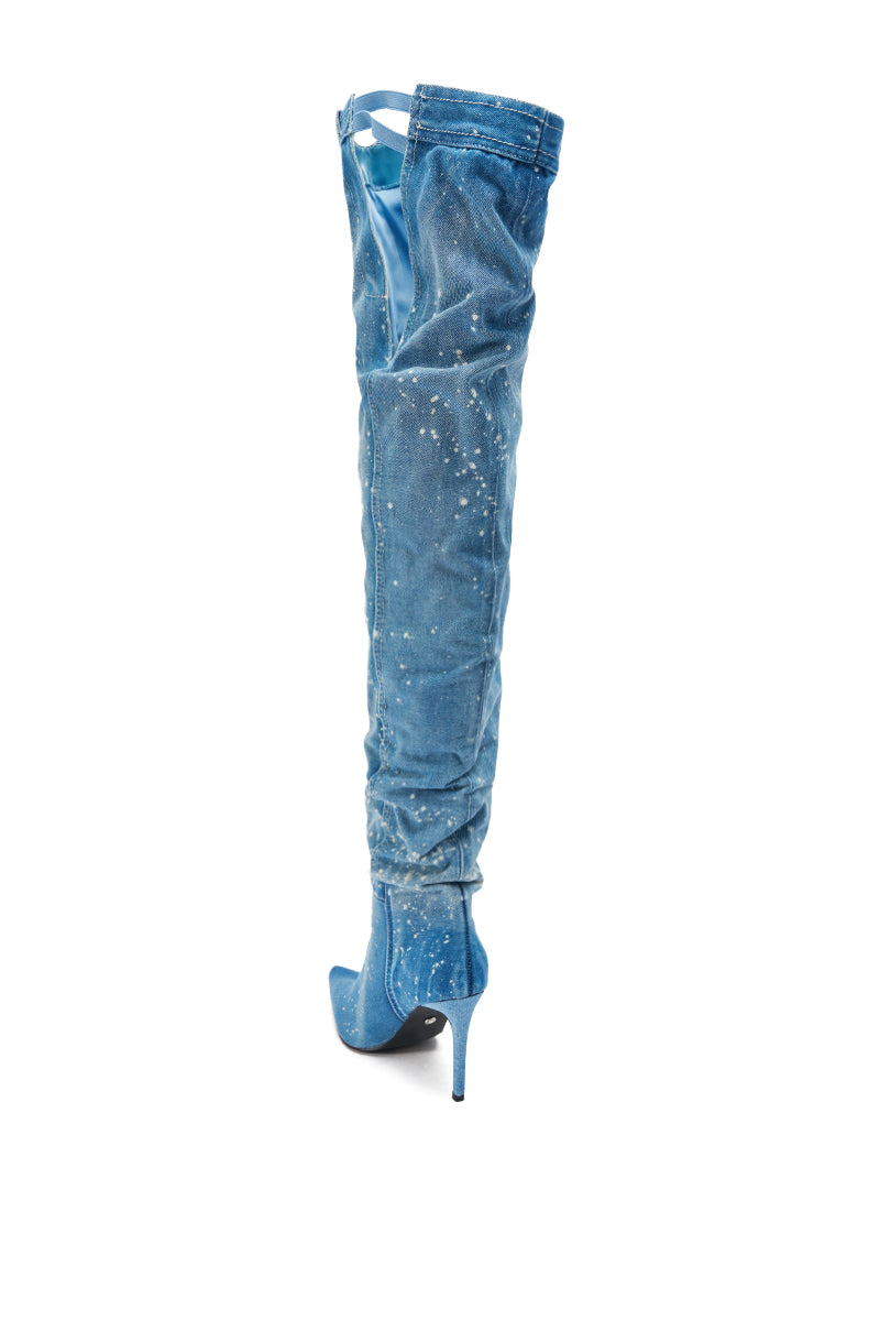 The AZALEA WANG JEANNI DENIM SPLATTER PAINTED STILETTO BOOT is a thigh-high, pointed toe high heel with distressed blue denim and subtle white paint splatters, shown against a white background.