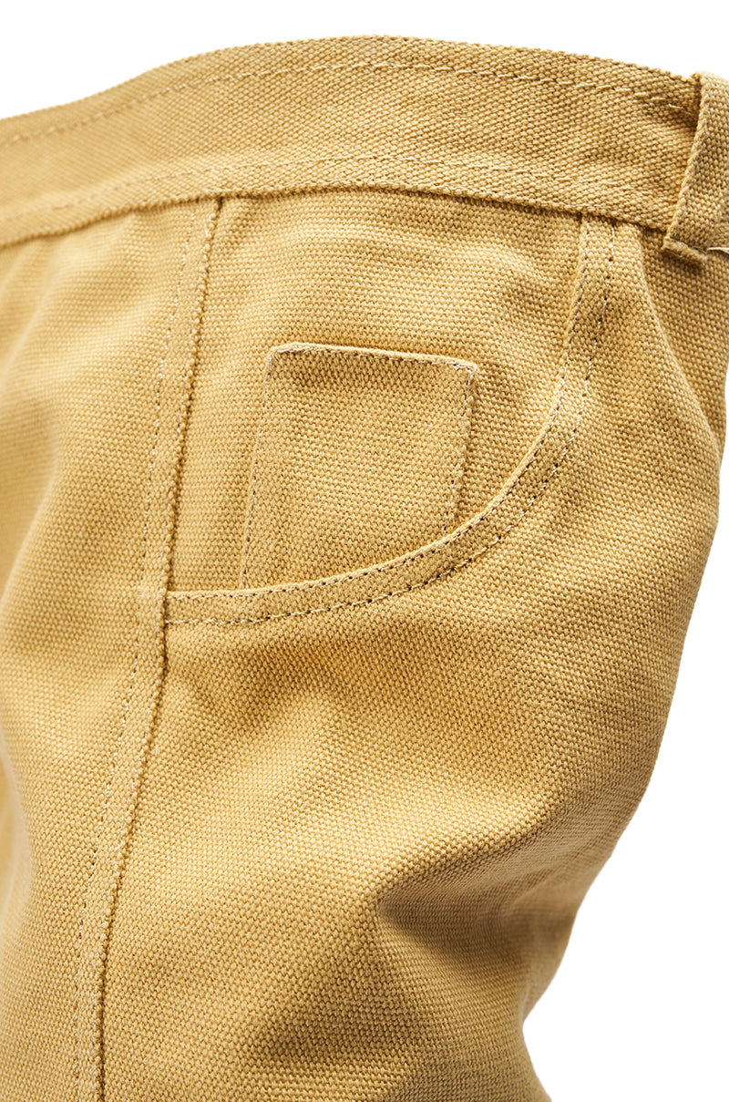 Close-up of tan fabric pants pocket with detailed stitching and a small rectangular patch, from the AZALEA WANG JEANNI TAN PANT DETAIL OVER THE KNEE BOOT—perfect for pairing with chic over the knee styles.