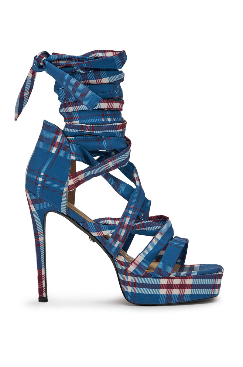 The AZALEA WANG JEMISHA BLUE PLAID PRINT PLATFORM STRAPPY SANDAL is a high-heeled, lace-up sandal with blue, red, and white plaid, multiple crisscross straps, long ankle ties, and a bold platform sole. 3
